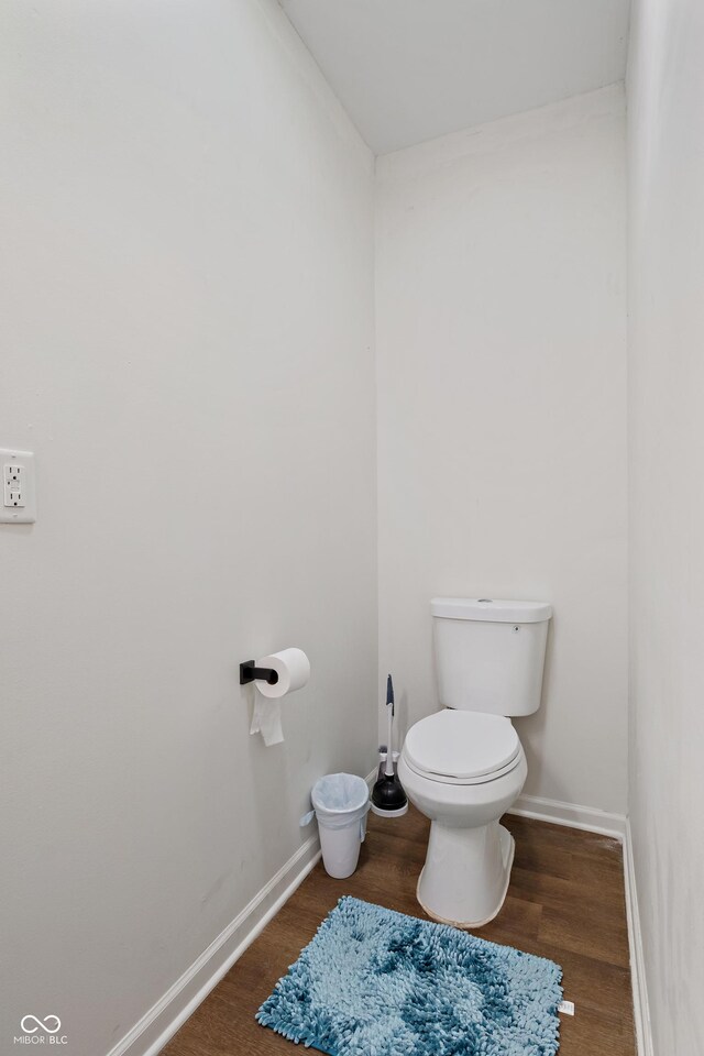 1728 N Delaware St, Indianapolis, IN 46202 - bathroom featuring wood finished floors, baseboards, and toilet
