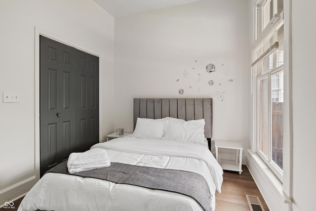 1728 N Delaware St, Indianapolis, IN 46202 - bedroom with multiple windows, wood finished floors, and baseboards