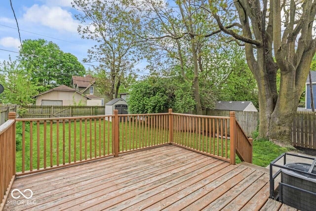 1505 Spann Ave, Indianapolis, IN 46203 - wooden deck featuring a storage unit and an outbuilding