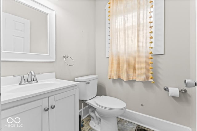 1505 Spann Ave, Indianapolis, IN 46203 - bathroom featuring baseboards, vanity, and toilet