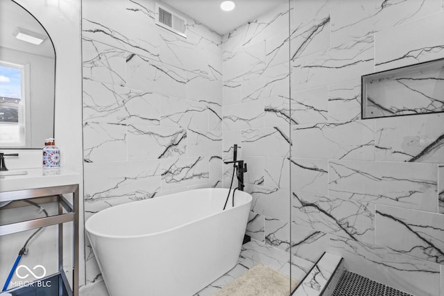 1505 Spann Ave, Indianapolis, IN 46203 - bathroom with tile walls, marble tiled floors, a freestanding bath, a marble finish shower, and vanity