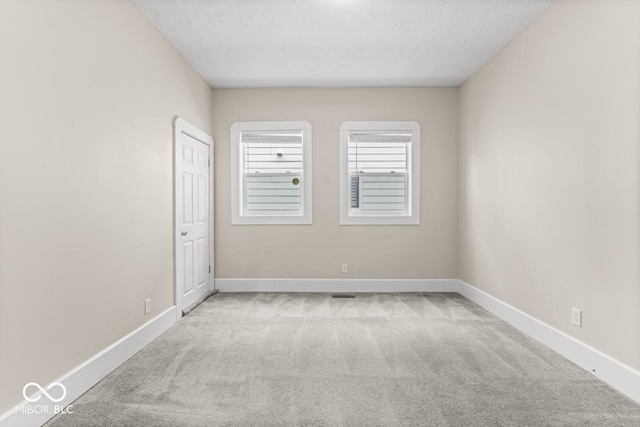 1505 Spann Ave, Indianapolis, IN 46203 - unfurnished room featuring carpet floors, a textured ceiling, and baseboards