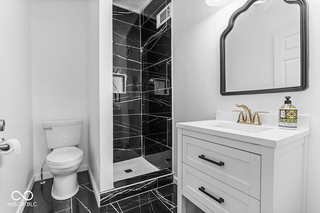 1505 Spann Ave, Indianapolis, IN 46203 - full bathroom with marble finish flooring, baseboards, toilet, vanity, and tiled shower