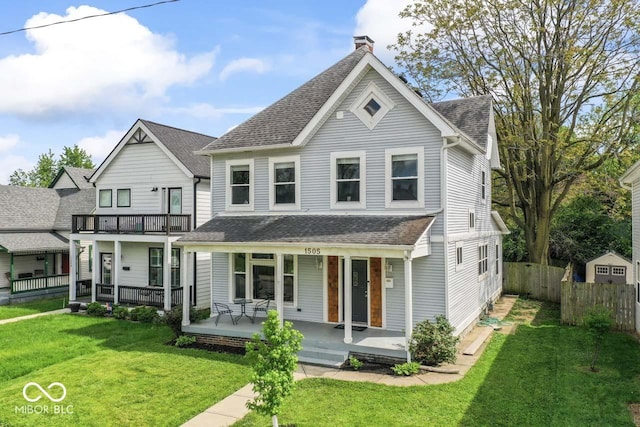 1505 Spann Ave, Indianapolis, IN 46203 - view of front of house featuring a porch, a shingled roof, and a chimney