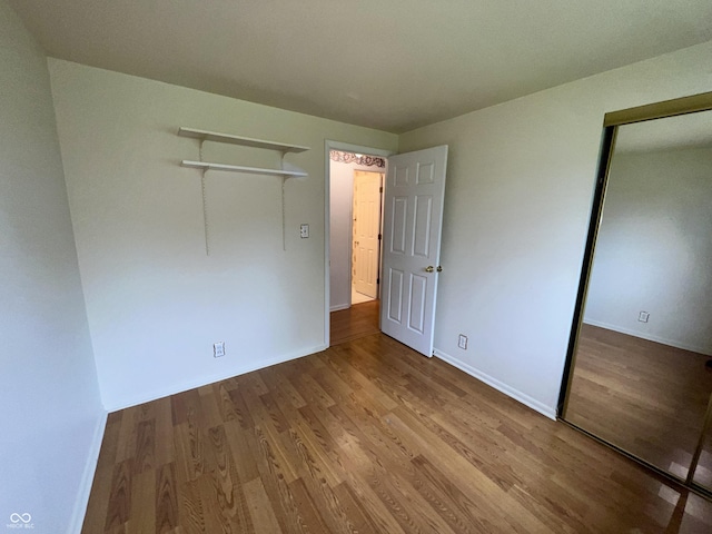 1949 Shenandoah Pl, Indianapolis, IN 46229 - unfurnished bedroom featuring wood finished floors, baseboards, and a closet