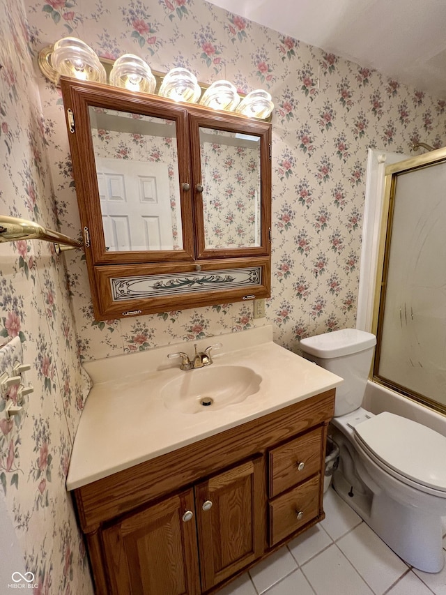1949 Shenandoah Pl, Indianapolis, IN 46229 - bathroom featuring tile patterned flooring, vanity, toilet, wallpapered walls, and bath / shower combo with glass door