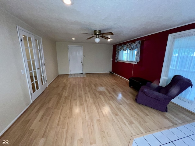 1949 Shenandoah Pl, Indianapolis, IN 46229 - unfurnished living room with wood finished floors, ceiling fan, baseboards, recessed lighting, and a textured ceiling