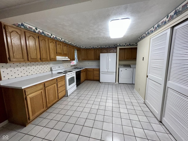 1949 Shenandoah Pl, Indianapolis, IN 46229 - kitchen with white appliances, washer and clothes dryer, under cabinet range hood, a sink, and a textured ceiling