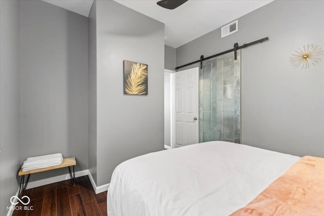 3818 Central Ave, Indianapolis, IN 46205 - bedroom with dark wood-type flooring, baseboards, and a barn door