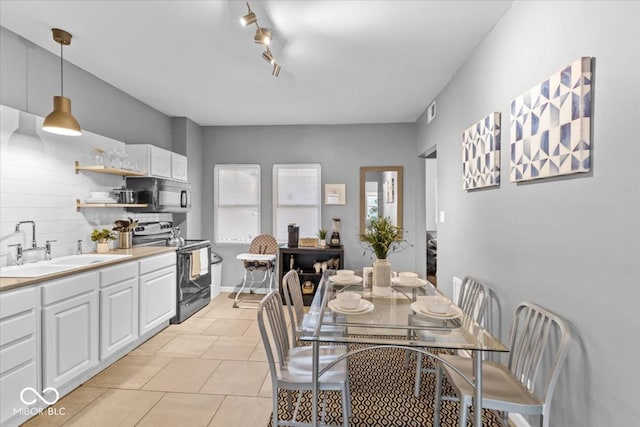 3818 Central Ave, Indianapolis, IN 46205 - dining room featuring light tile patterned floors and track lighting