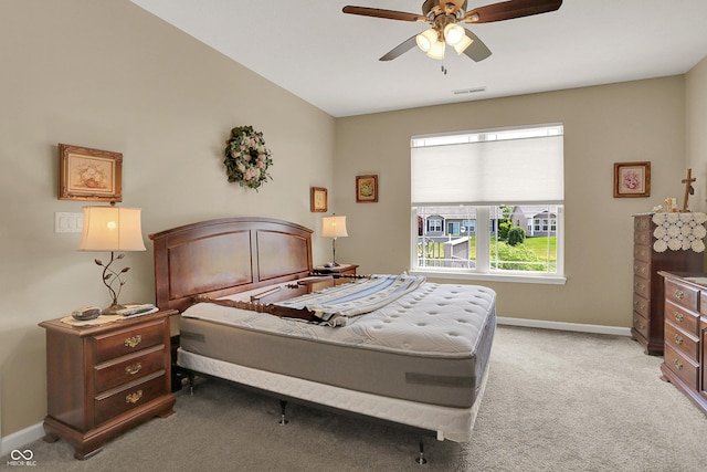 bedroom with baseboards, ceiling fan, visible vents, and light colored carpet