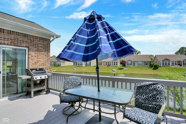 deck with a yard, grilling area, a water view, and a residential view