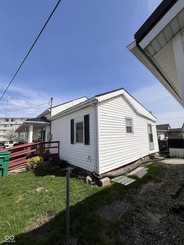 view of side of home featuring a yard