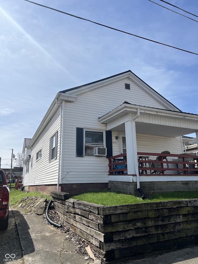 view of front of property with covered porch and cooling unit