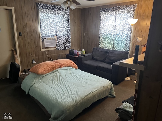carpeted bedroom featuring wooden walls, cooling unit, multiple windows, and a ceiling fan