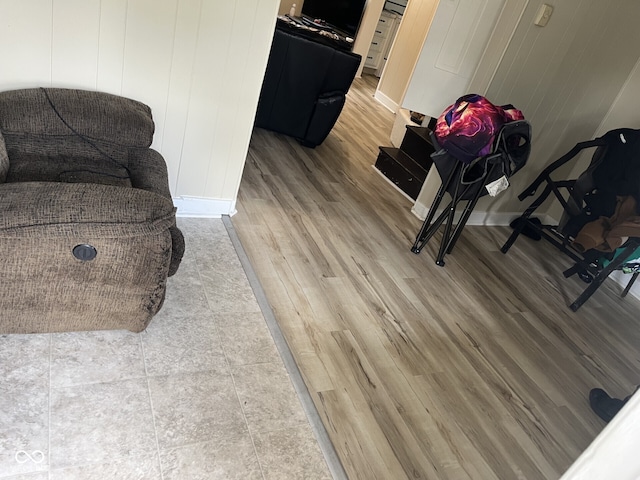 sitting room with light wood-type flooring and baseboards