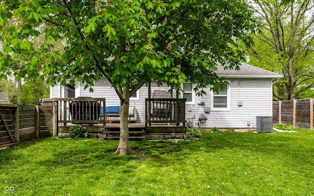 back of house with a wooden deck, roof with shingles, and cooling unit