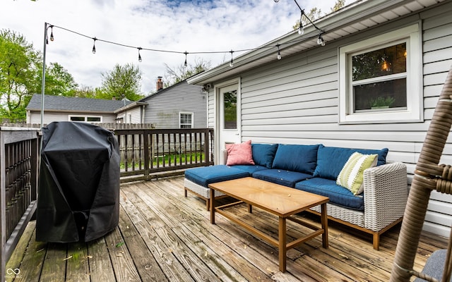 wooden terrace featuring outdoor lounge area and a grill