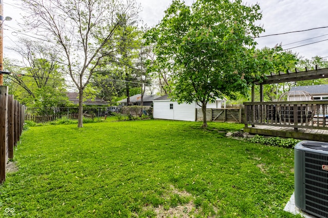 view of yard with central AC unit and a deck
