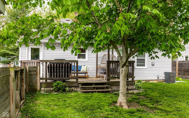 rear view of property with a wooden deck and central air condition unit