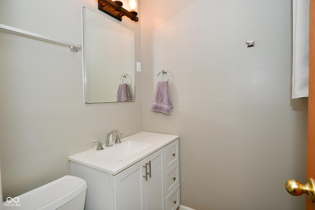 bathroom featuring toilet and vanity