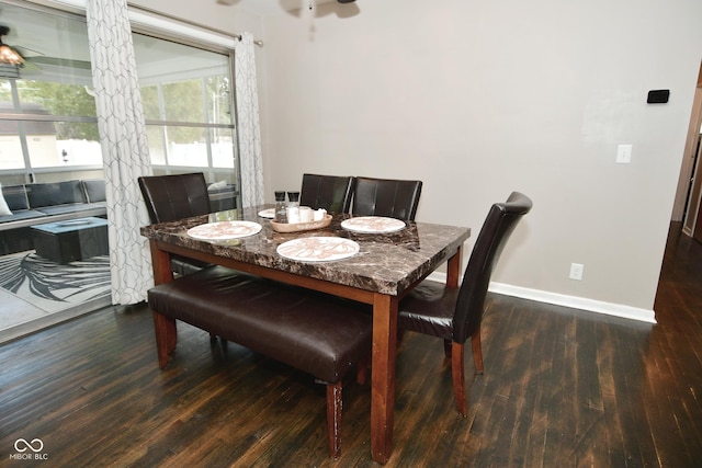 dining area with baseboards, wood finished floors, and a ceiling fan