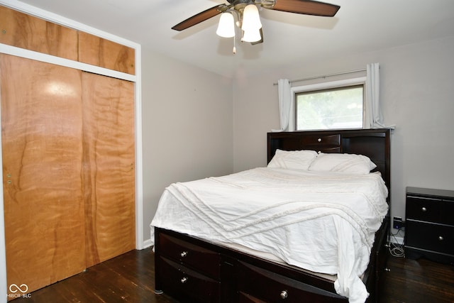 bedroom featuring dark wood-style flooring, a closet, and a ceiling fan