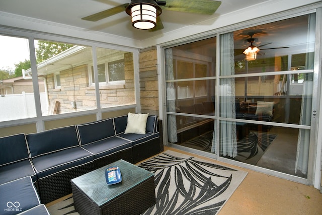 unfurnished sunroom with a ceiling fan and an outdoor hangout area