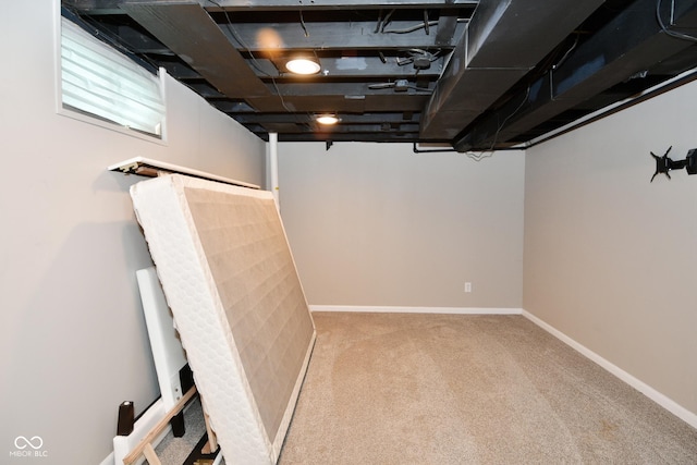 finished basement featuring carpet flooring and baseboards