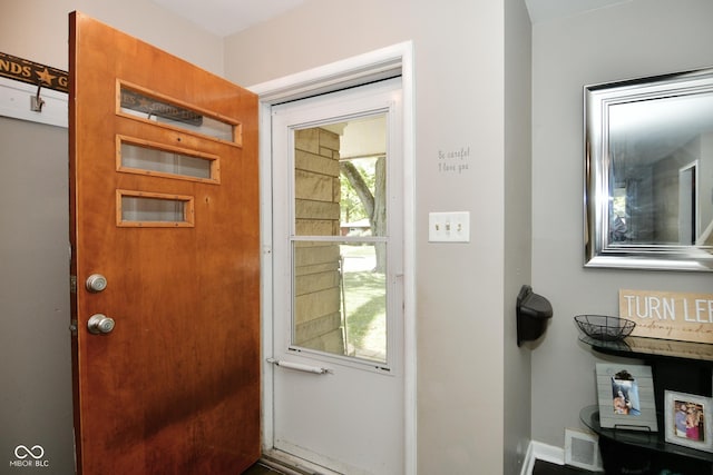 doorway to outside with baseboards