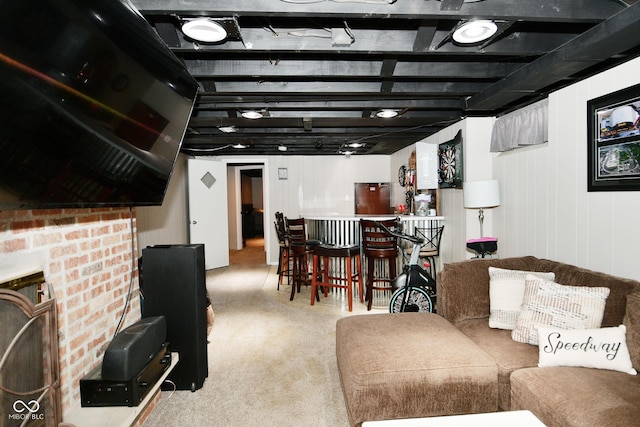 carpeted living area with a bar