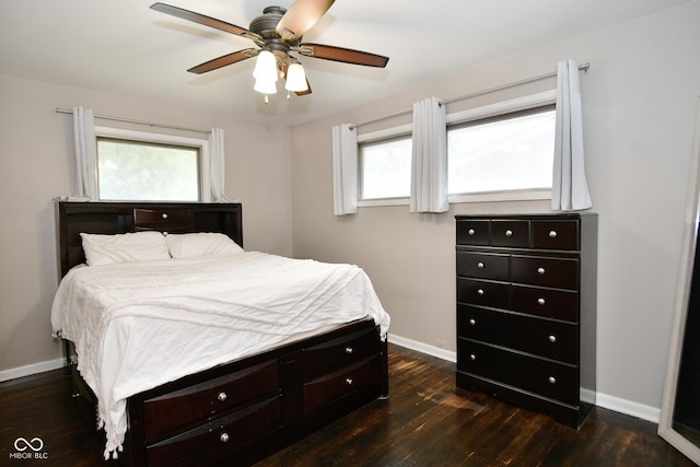 bedroom featuring dark wood finished floors, baseboards, and a ceiling fan