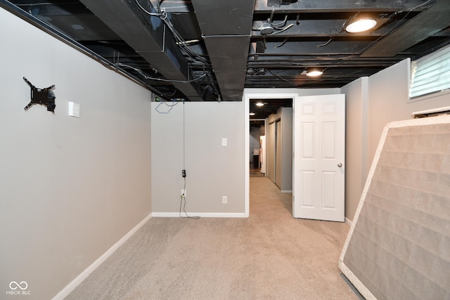finished below grade area with baseboards and carpet floors