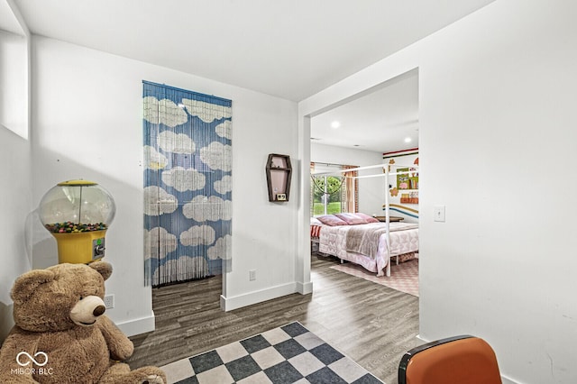 hall with wood finished floors, baseboards, and recessed lighting