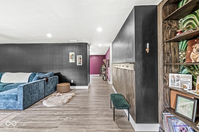 corridor with wood finished floors, recessed lighting, and baseboards