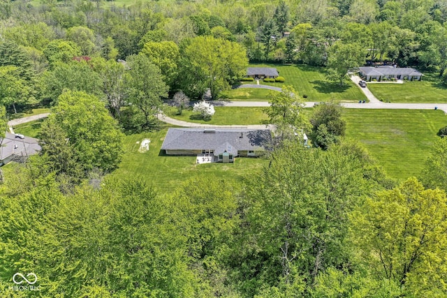 aerial view of property and surrounding area featuring a forest