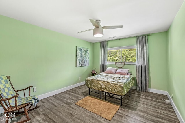 bedroom with baseboards, wood finished floors, and a ceiling fan