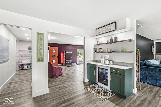 indoor dry bar with wine cooler, wood finished floors, and baseboards