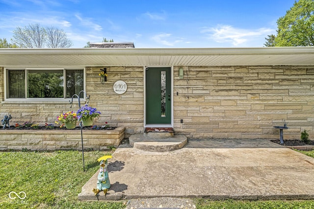 view of exterior entry featuring stone siding