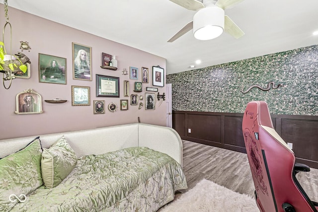 bedroom featuring wallpapered walls, wood finished floors, wainscoting, recessed lighting, and ceiling fan