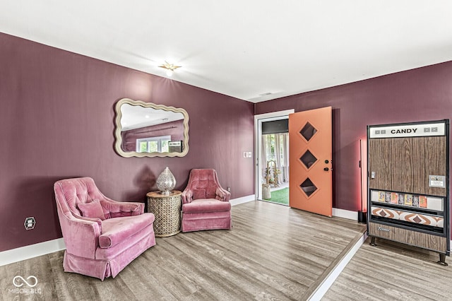 living area featuring wood finished floors and baseboards