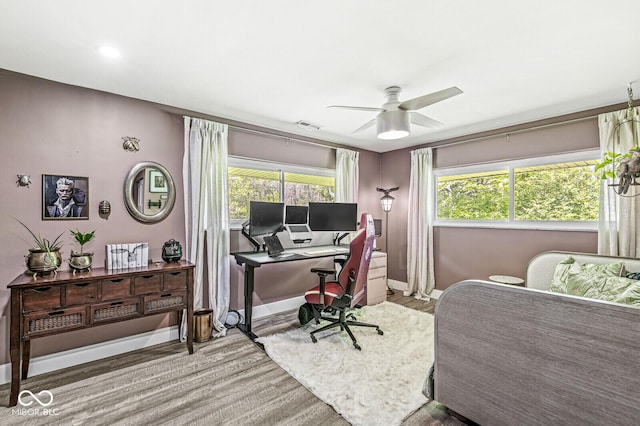 office area featuring wood finished floors, a ceiling fan, plenty of natural light, and baseboards