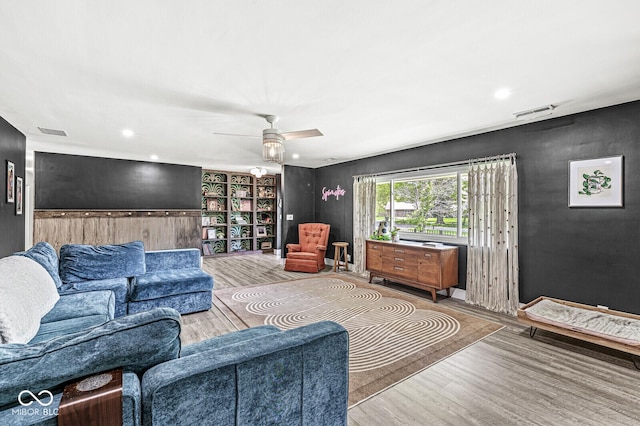 living room featuring wood finished floors and ceiling fan