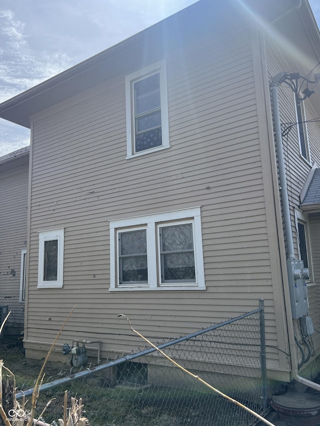 view of side of home with fence