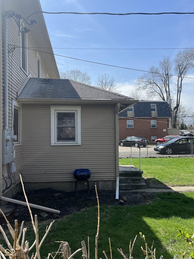 view of home's exterior featuring roof with shingles