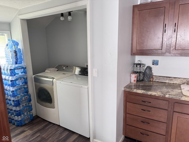 washroom with washer and dryer and dark wood finished floors