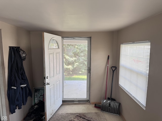 entryway featuring carpet and baseboards