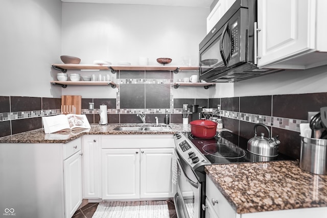 2407 N Capitol Ave, Indianapolis, IN 46208 - kitchen featuring a sink, stainless steel electric stove, black microwave, tasteful backsplash, and white cabinets