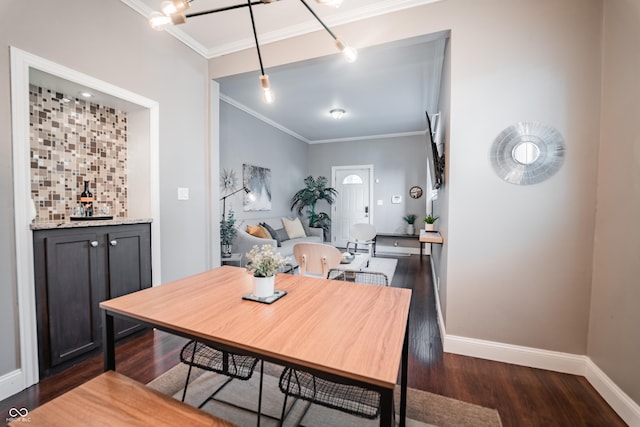 2407 N Capitol Ave, Indianapolis, IN 46208 - dining room with wood finished floors, crown molding, baseboards, and a bar