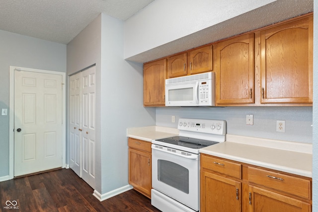 4136 Orchard Valley Ln, Indianapolis, IN 46235 - kitchen with white appliances, dark wood-type flooring, light countertops, baseboards, and brown cabinetry